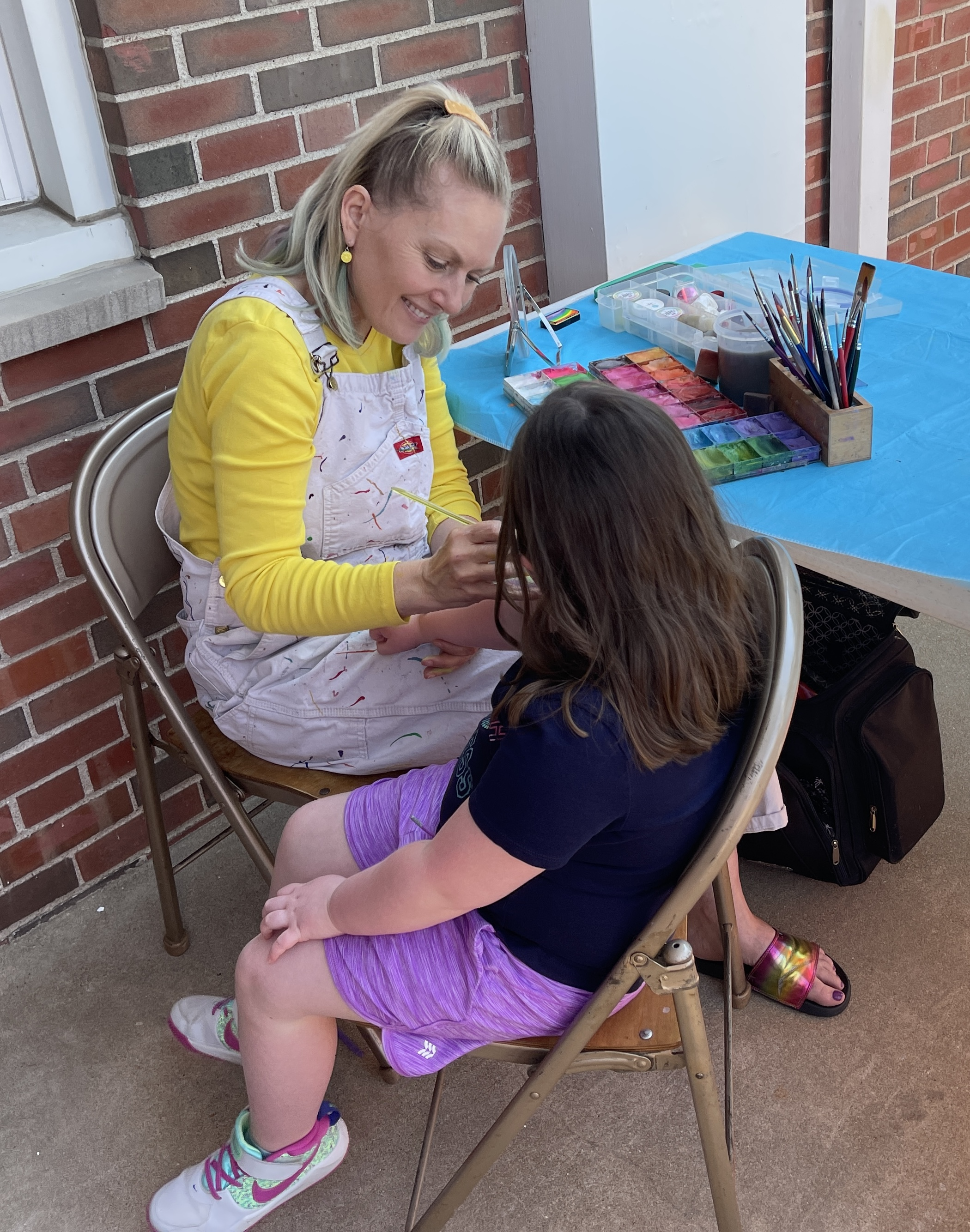 Ginger Creating A Design On Child's Hand